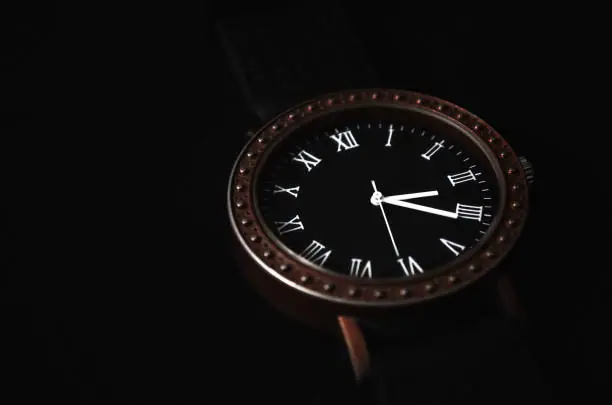 A Luxora timepiece with a Roman-numeral dial on a dark background